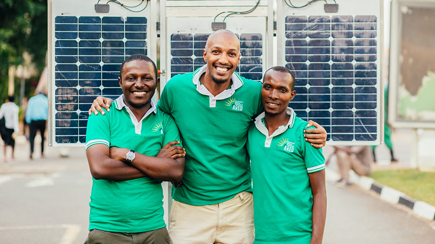 Nyakarundi (centre) and some of his staff. He has developed a technology that uses solar energy to power devices such as telephone and connect people, especially rural communities to internet. Courtesy.
