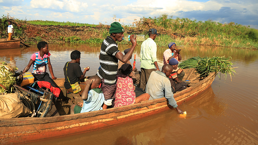 Sharita Island residents board a boat to the market in Rweru Sector, Bugesera District on Friday. They will be relocated to Rweru model village soon. Sam Ngendahimana.