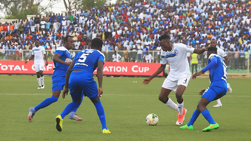 Enyimba midfielder dribbles past Rayon Sports players
