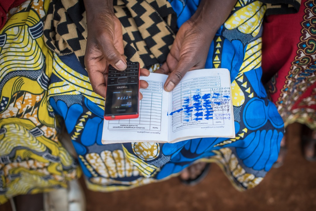 One of the members of the group during pre-save and after saving with a passbook record that was used before the SAVE platform. Joan Mbabazi.