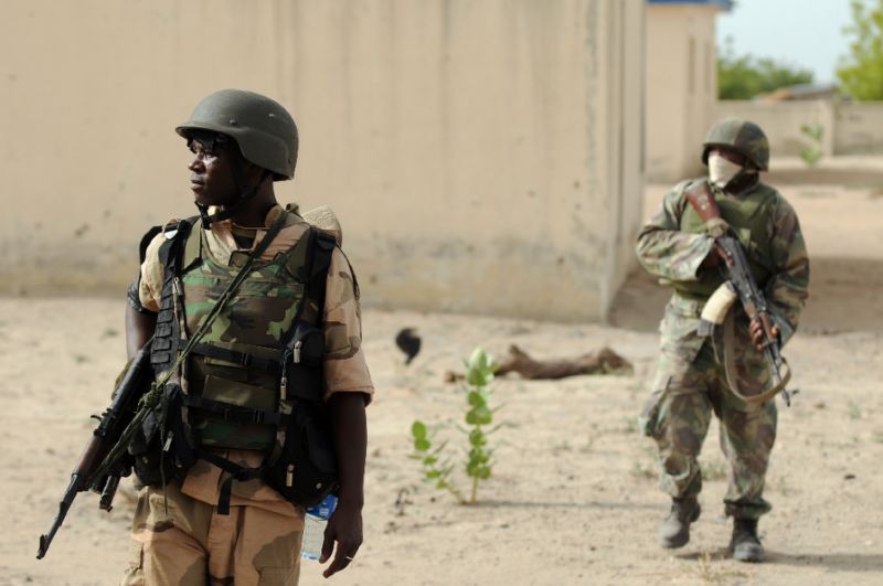 Nigerian soldiers patrol in the north of Borno state close to a former camp of Boko