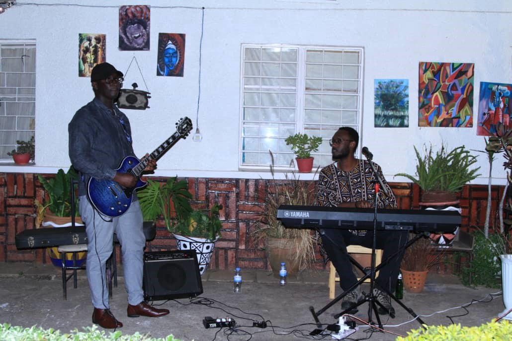 Guests were entertained by pianist  Mike Kayihura and his guitariest (left).