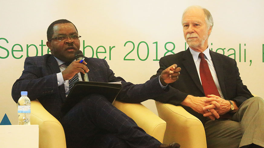 Trade and Industry Minister Vincent Munyeshyaka delivers his remarks as Richard Newfarmer, International Growth Center Country Director, looks on in Kigali yesterday. Sam Ngendahimana.