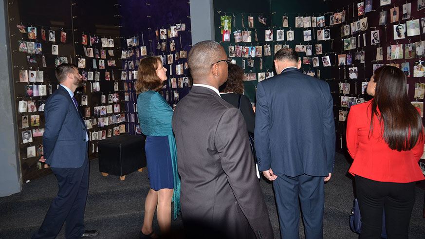 Visitors look at some of the pictures of victims of the Genocide against the Tutsi inside Kigali Genocide Memorial. Photo by Sam Ngendahimana.