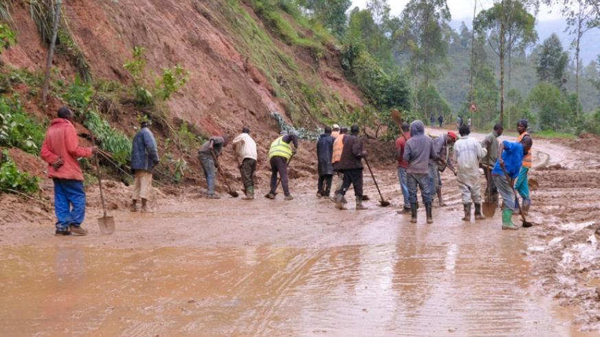 Gakenke residents remove mud from a road after heavy rains that left the road impassable. File.