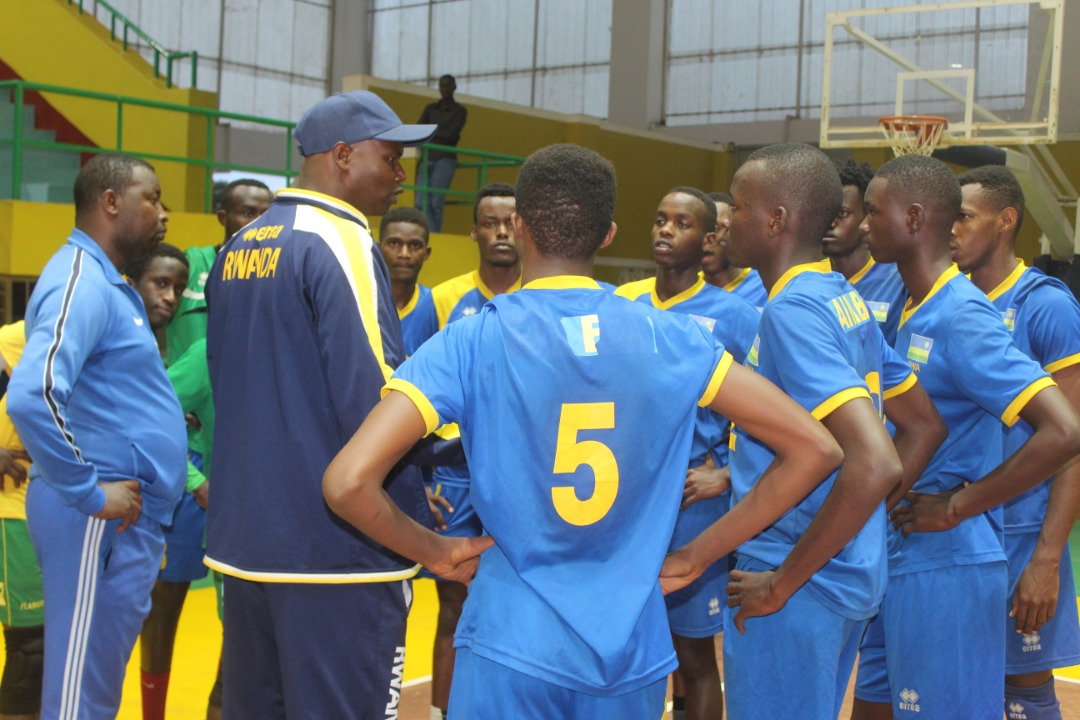 Head coach Paul Bitok gives instructions to players in a past training session at Amahoro Indoor Stadium. File photo