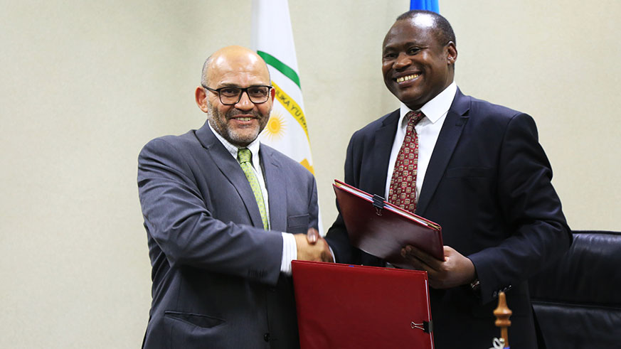 The World Bank Group  the Country Manager Yasser El- Gammal  and  Uzziel Ndagijimana Minister of Finance and Economic planning pose for a photo after signing  the MoU in Kigali  yesterday (Sam Ngendahimana)