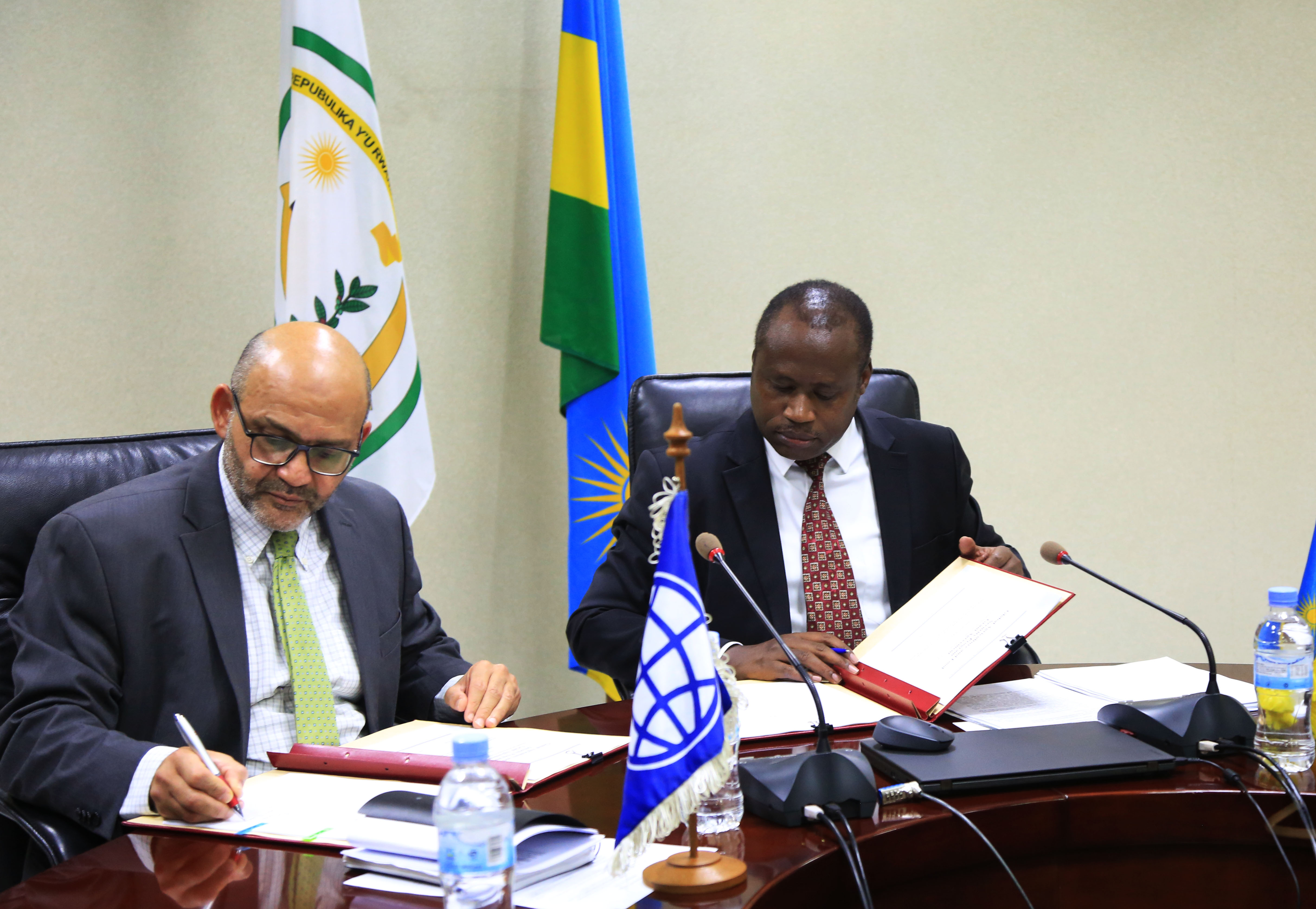 The World Bank Group Country Manager Yasser El-Gammal  (left) and  Uzziel Ndagijimana, the Minister for Finance and Economic Planning, sign the deal in Kigali  yesterday. Sam Ngendahimana.