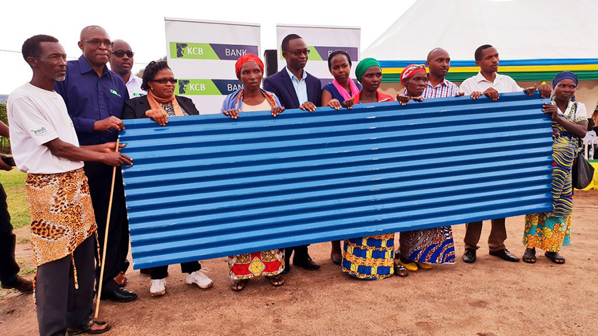 KCB Bank Rwanda handed over 1500 pieces of iron sheets to residents of Ruhango district who were affected by the heavy rainfall earlier this year. (Courtesy)