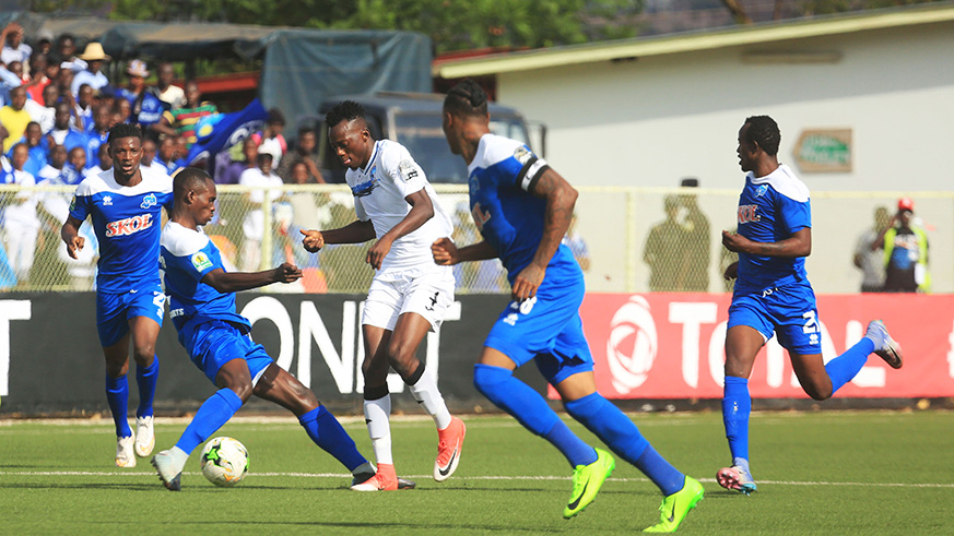 Enyimba FC forward Sunday Damilare (#4) tries to go past Rayon Sportsu2019 defender Gabriel Mugabo and his teammates during the first leg match at Kigali Stadium on Sunday. Sam Ngendahimana.