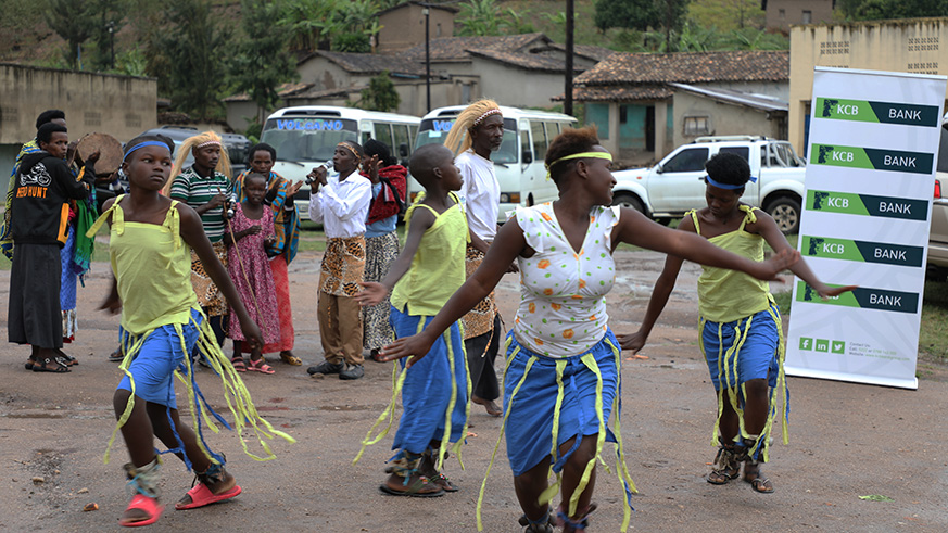Residents at Gisanga Cell, Mbuye Sector in Ruhango District put up some entertainment after receiving the iron sheets from KCB. (Kelly Rwamapera)