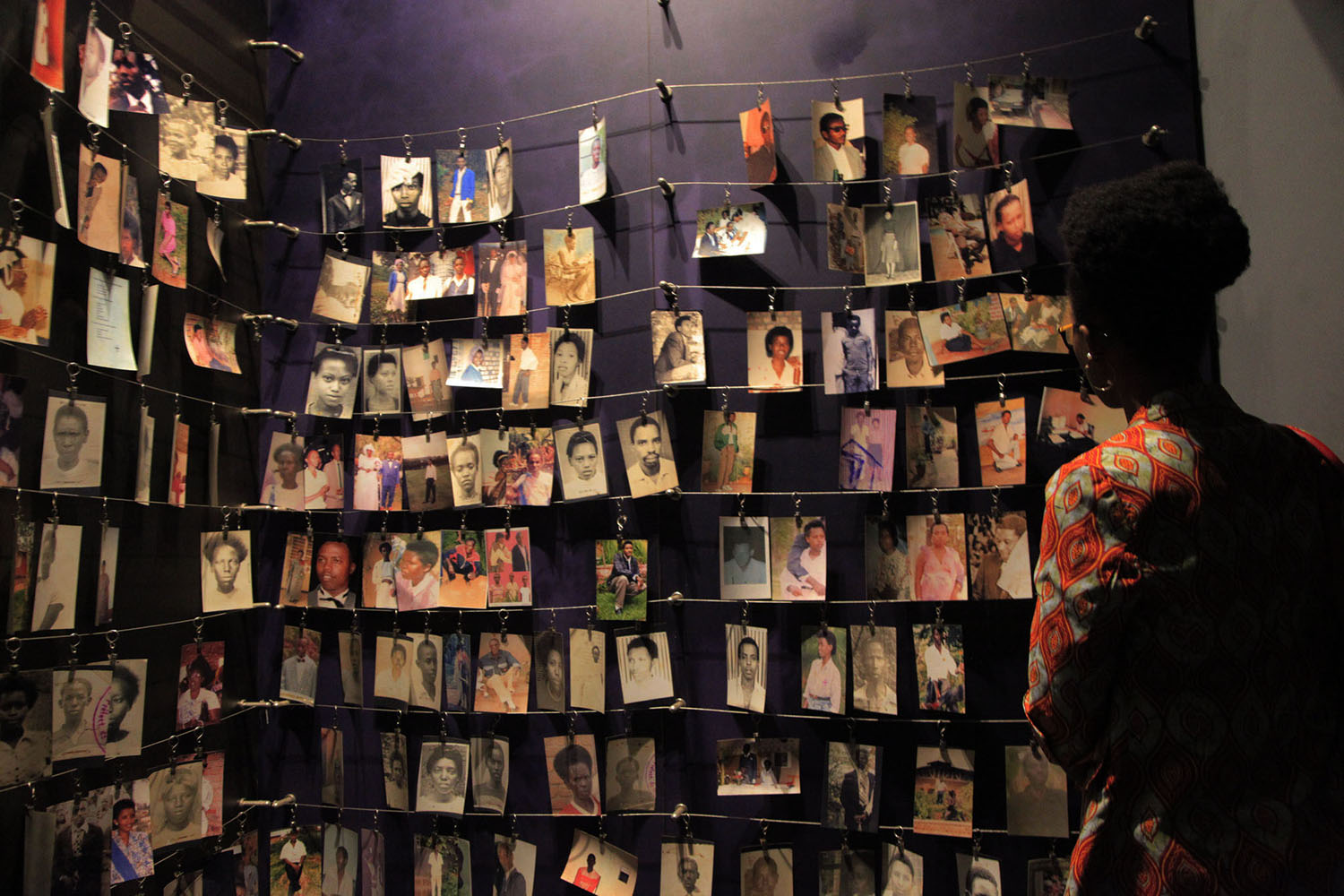 A visitor looks at pictures of victims of the 1994 Genocide against the Tutsi inside Kigali Genocide Memorial. Sam Ngendahimana.