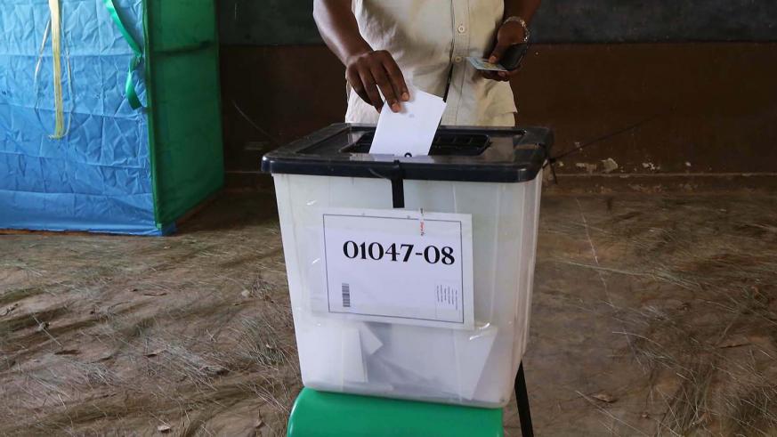 A man casts his vote at Groupe Scolaire Camp Kigali polling station
