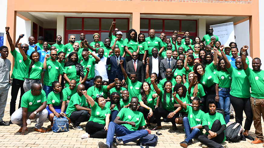 African youth volunteers pose a group photo with government officials and trainers. (Frederic Byumvuhore)