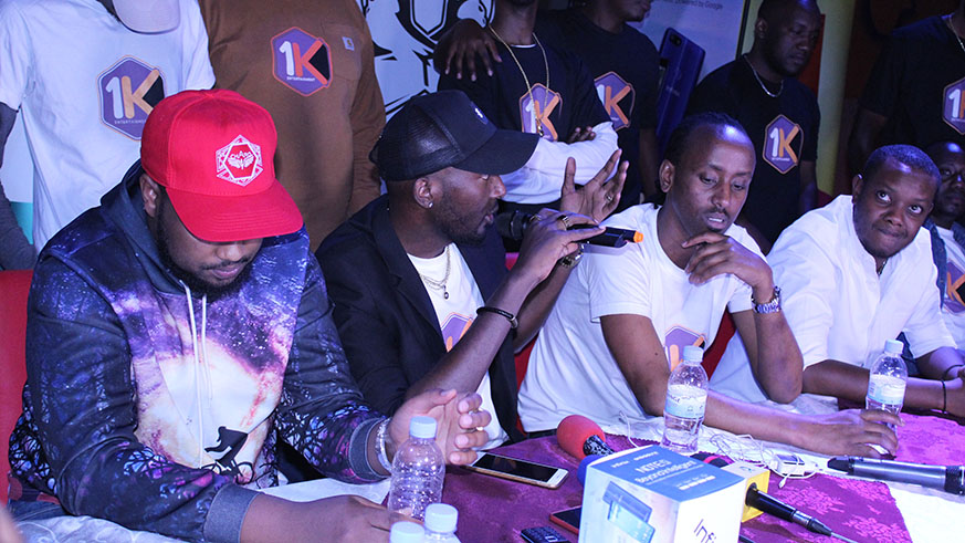 DJ Pius (with a microphone) speaks to the journalists during the launch of his latest song, and music label at Wankanda Villa on Thursday evening. Photo by Charles Ndushabandi.
