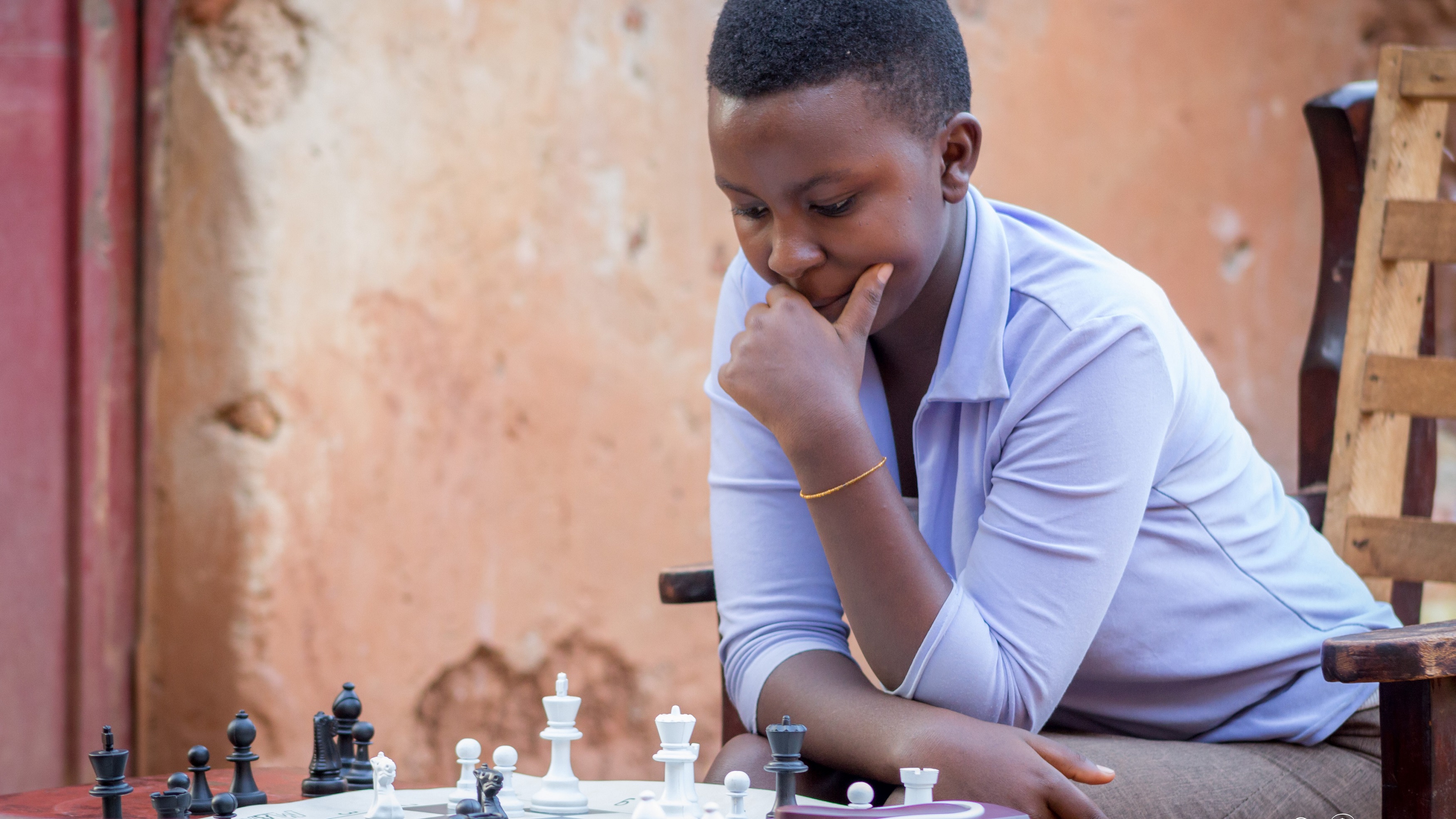 Joselyne Uwase, 15, could earn a title if she wins 50% of her games in the ongoing Chess Olympiad in Georgia. The teen is seen here playing with a friend at her home in Gikondo last year. File photo