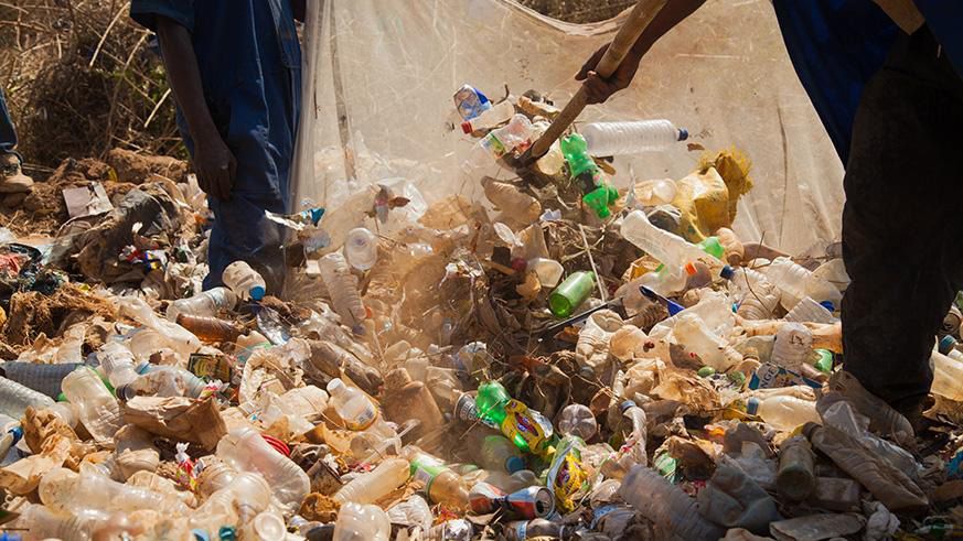 People sort plastic bottles at a dumping site. (File)