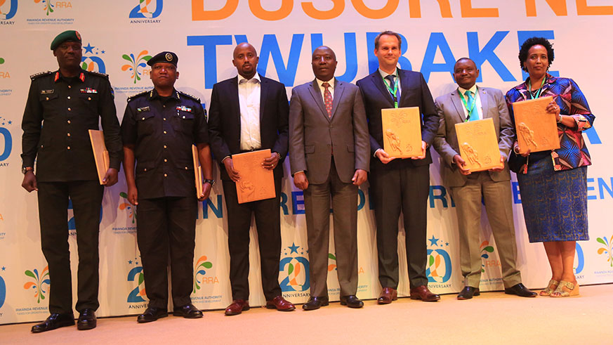 Prime Minister Edouard Ngirente poses with representatives of RRAâ€™s best partner institution and best taxpayers of fiscal year 2017/18 during the awarding ceremony in Kigali yesterday. Sam Ngendahimana.