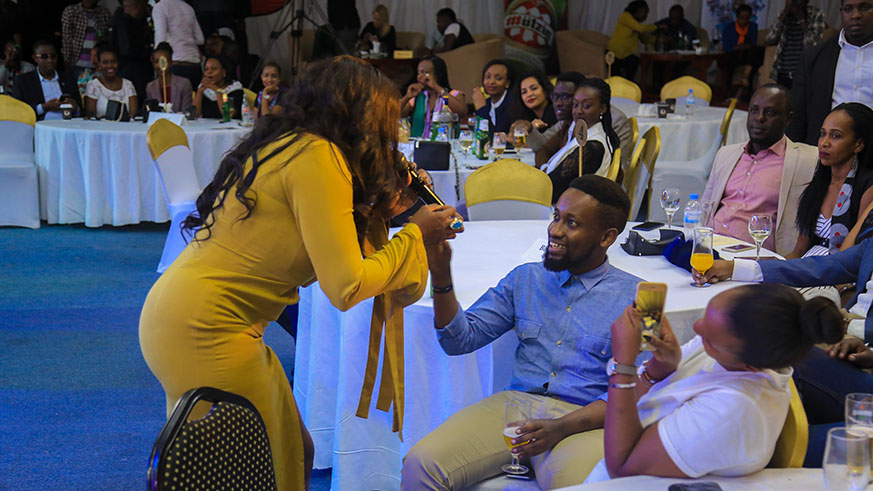 During her performance, Waje joined this fan in his seat to sing for him. (Faustin Niyigena)