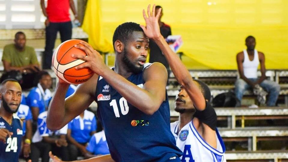 REG center Olivier Shyaka shields the ball from a KPA player during their first game on Sunday, which ended 56-39 in favor of the Rwandan side. Courtesy