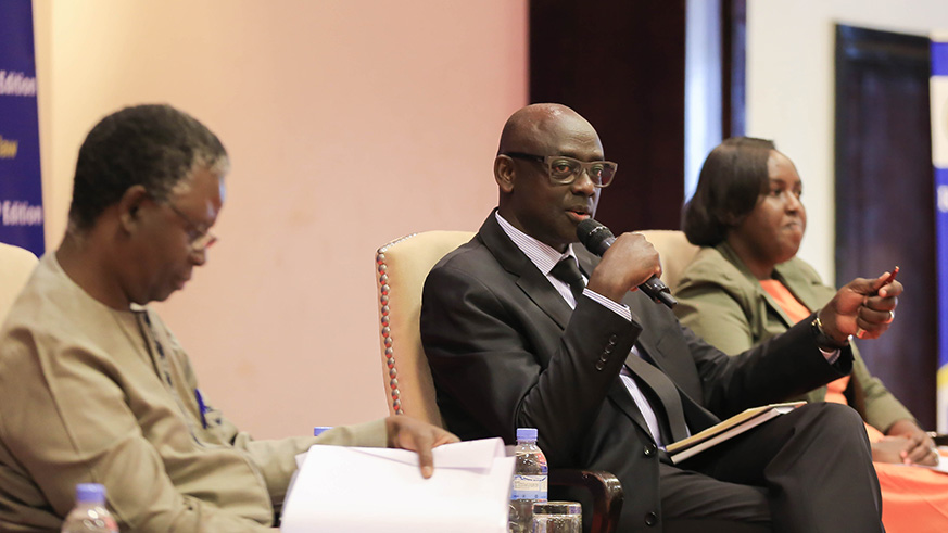 Minister for Justice Johnston Busingye speaks during the 5th Rwanda Governance Scorecard event as UN Resident Coordinator Fodu00e9 Ndiaye and Franu00e7oise Kayitare Tengera, Deputy Vice-Chancellor of Finance at University of Rwanda looks on in Kigali yesterday. Nadege Imbabazi.