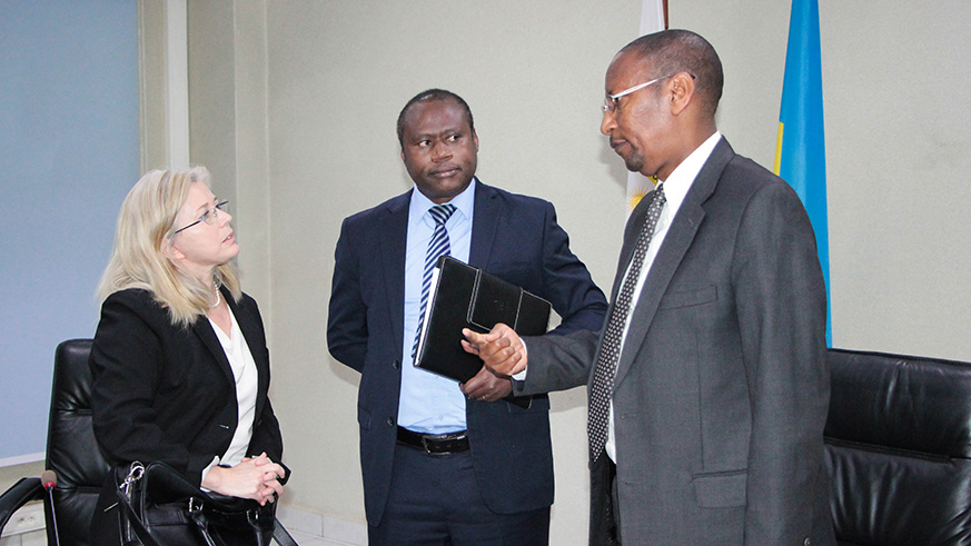 L-R: Laure Redifer, the IMF mission chief to Rwanda, Minister for Finance Uzziel Ndagijimana, and Governor of national Bank of Rwanda John Rwangombwa chat after the news conference that focused on policies that could support the completion of the tenth and final review of Rwandau2019s macroeconomic programme supported by the IMF Policy Support Instrument in Kigali yesterday. Courtesy.