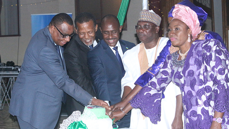 Nigeria High Commissioner to Rwanda Adamu Onoze Shuiabu (2nd right) is joined by Education Minister Eugene Mutimura (centre) and other members of diplomatic corps to cut a cake at the event to mark Nigeriau2019s 58th Independence, in Kigali. Courtesy photos.
