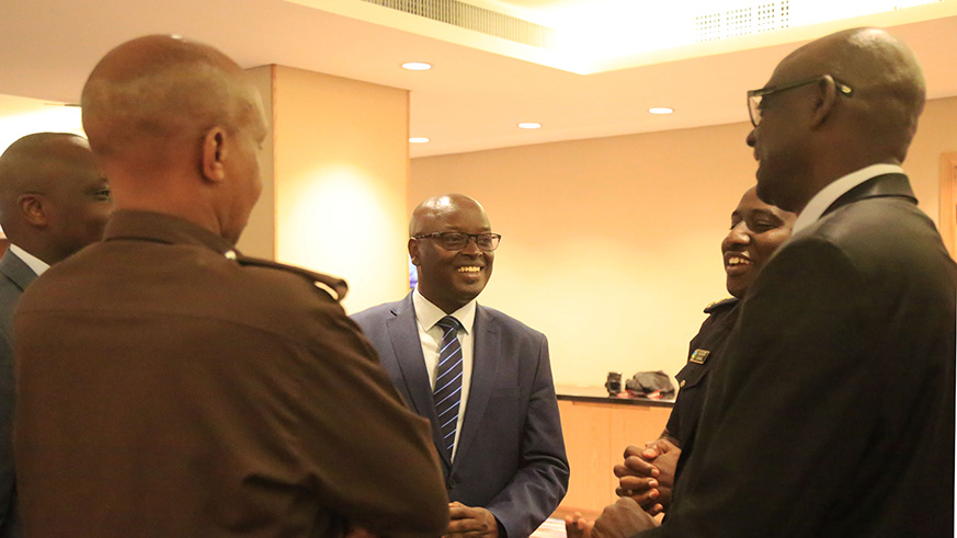 Officials chat after the opening ceremony of Rwanda Investigation Bureauu2019s consultative workshop on services delivery for fair justice in Rwanda yesterday. Sam Ngendahimana.
