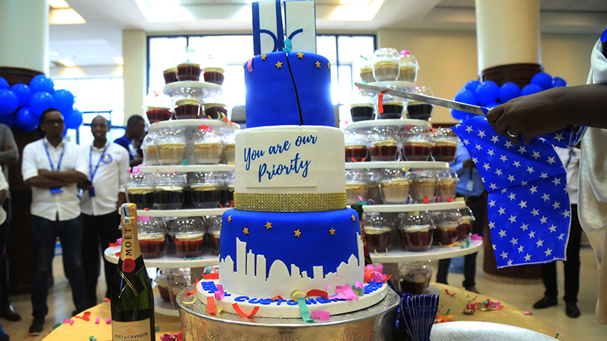 Bank-of-Kigali-'s-customers-and-staff-share-a-cake-to-celebrate-their-achievements.