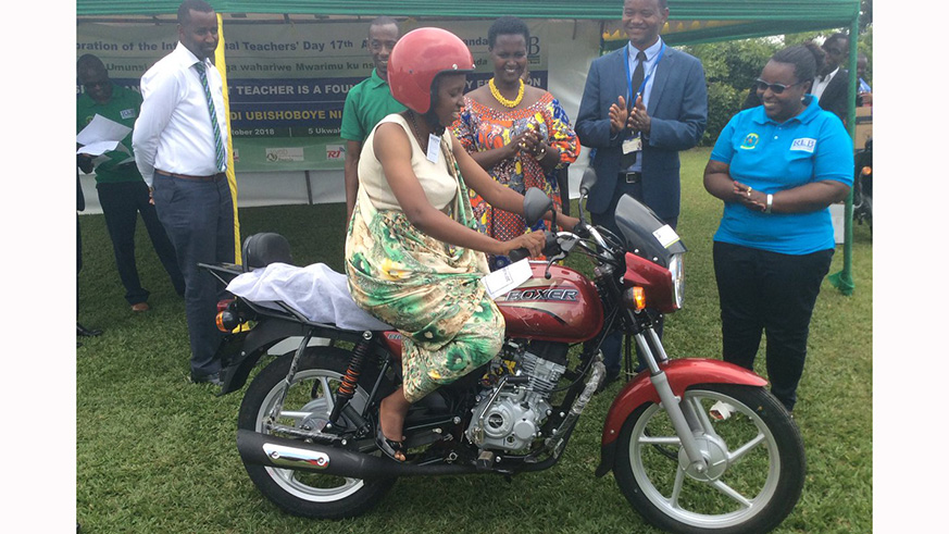 Berthilde Mukangenera, a teacher at Groupe Scolaire Kimironko 2, Gasabo District, was awarded a motorcycle and a laptop as the best performing teacher in Kigali City. Courtesy.