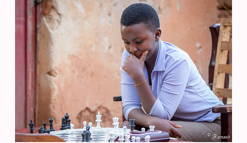 Joselyne Uwase, 15, is seen here playing chess with Sandrine Uwase (not in photo) at the latteru2019s home in Gikondo earlier this year. Sandrine, also aged 15, is the reigning national champion. File photo.