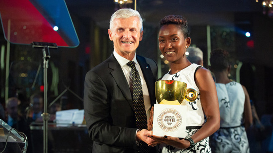 Andrea Illy, Chairman of illycaffu00e8, presents the 2018 Ernesto Illy International Coffee Award to Rwanda's Ngororero Coffee Washing Station, represented by Philotu00e9e Muzika, designating their coffee beans as Best of the Best. Sam Ngendahimana.