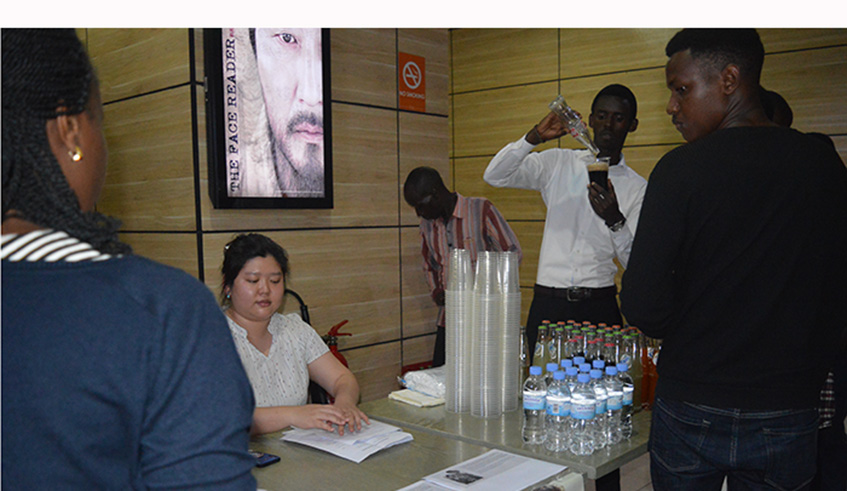 Cinemagoers being served with soft drinks before the film. 