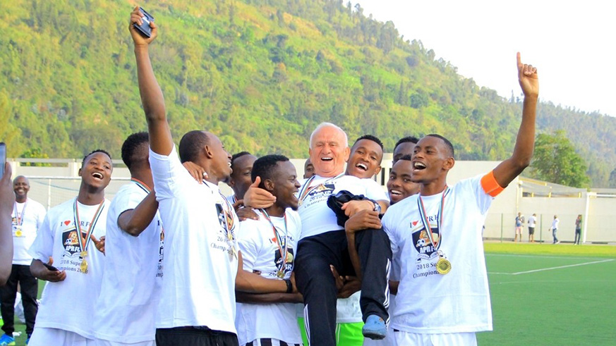 Ljubomir Petrovic is lifted in the air by celebrating APR players after guiding the military side to their first Super Cup title at Umuganda Stadium on Saturday. Courtesy. 