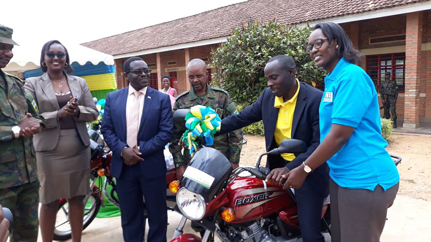 Rose Baguma, the Director General of Education Planning in the Ministry of Education, hands over a motorbike to a best performed teacher in the Northern Province. / Regis Umurengezi