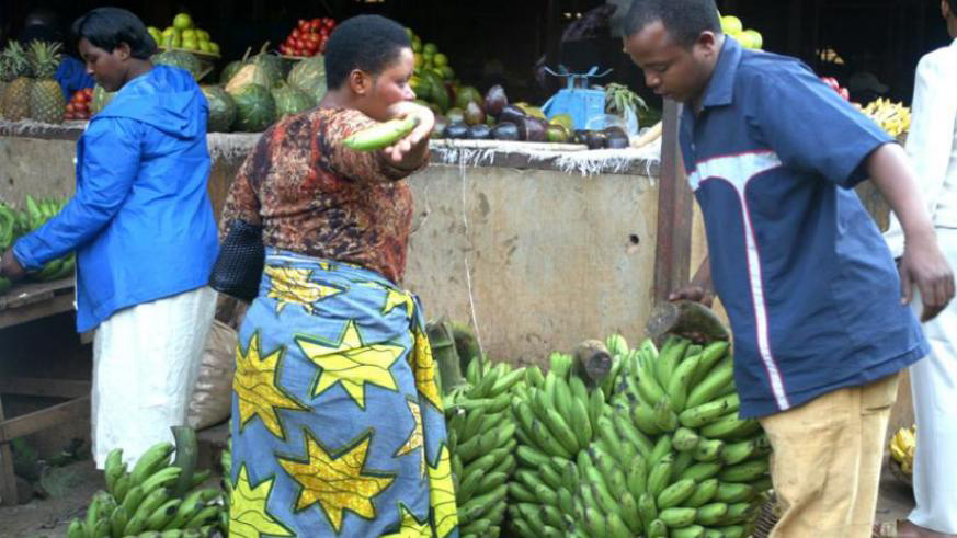 A  man buys bananas from Kimironko market. File.