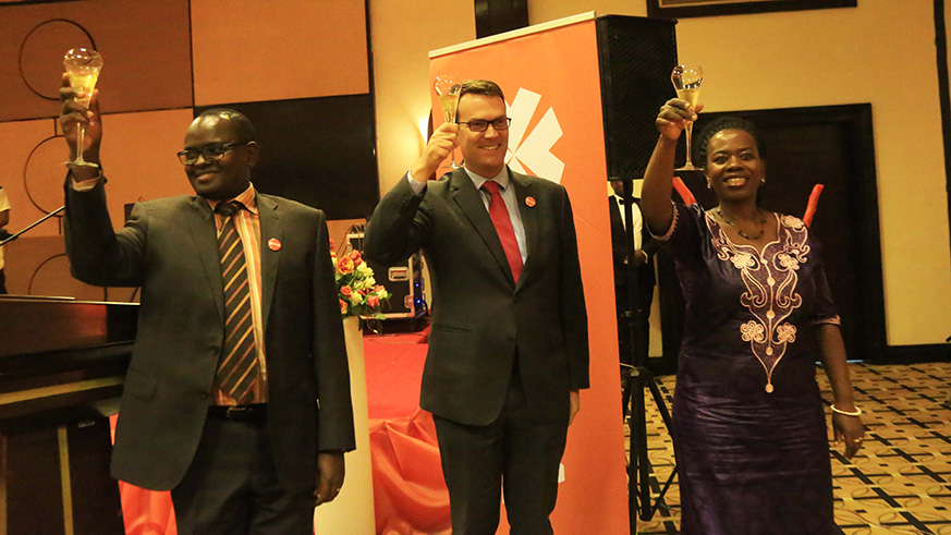 L-R: MUA Country Managing Director Gaudens Kanamugire , MUA Group CEO Bertrand Casteres, and Vice Governor of National Bank of Rwanda Monique Nsanzabaganwa toast during the launch of MUA Rwanda .