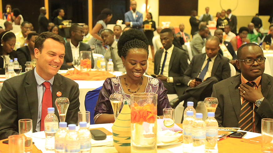 Guests share a light moment during the event. Photos by Sam Ngendahimana.