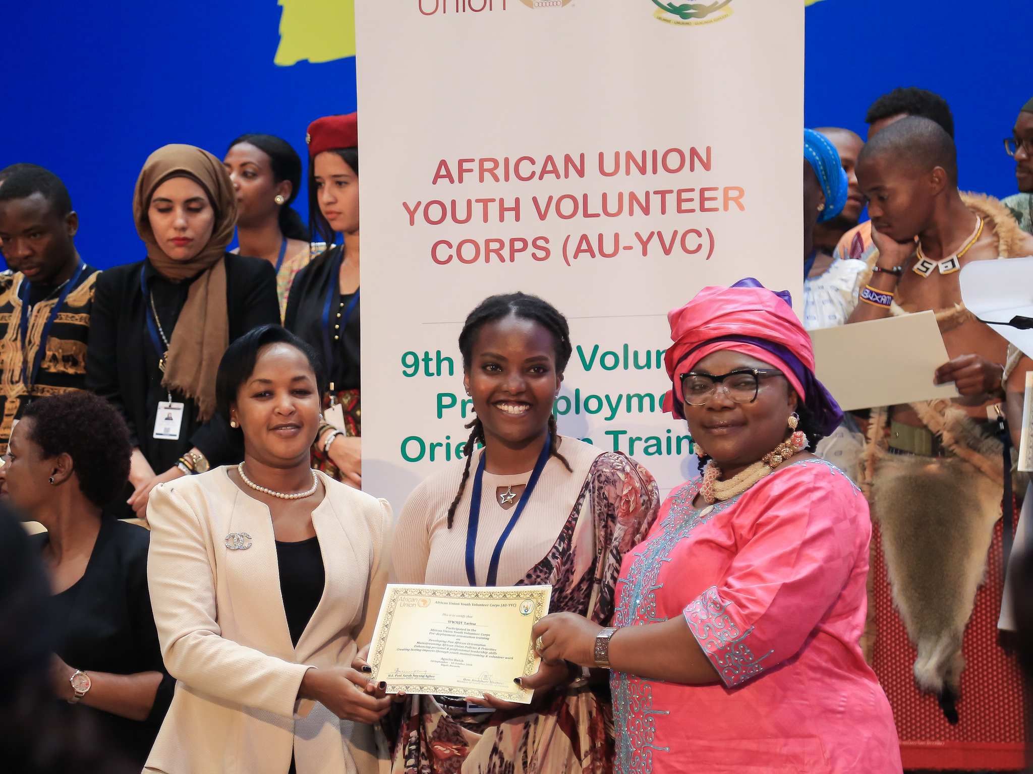 One of the graduate volunteers pause for a photo with Minister for Youth Rosemary Mbabazi (L) and Sarah Agboh, the AU Commissioner Human Resources, Science and Technology. / Nadege Imbabazi