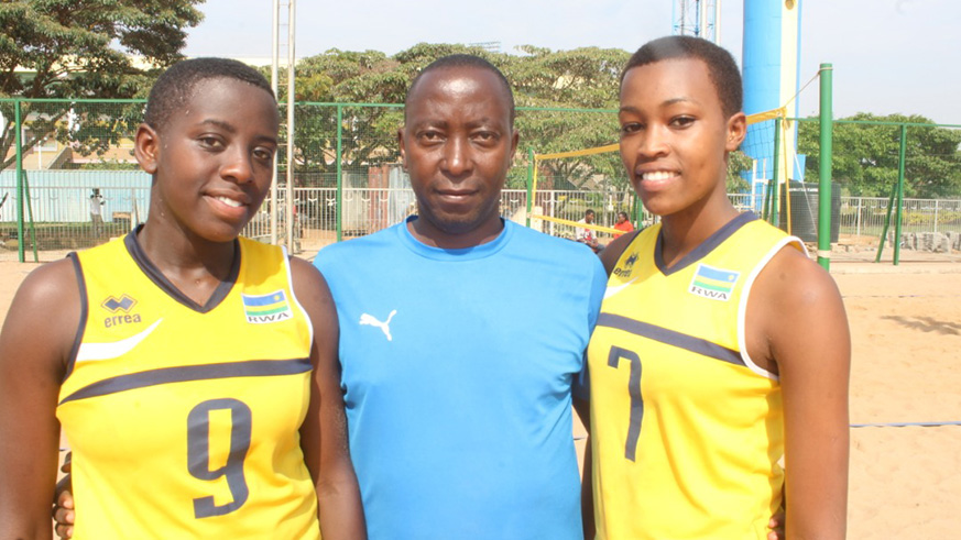 Penelope Musabyimana (left) and Valentine Munezero (right) pose with their coach Christophe Mudahinyuka (middle) after a past training session at Amahoro Stadium. File photo
