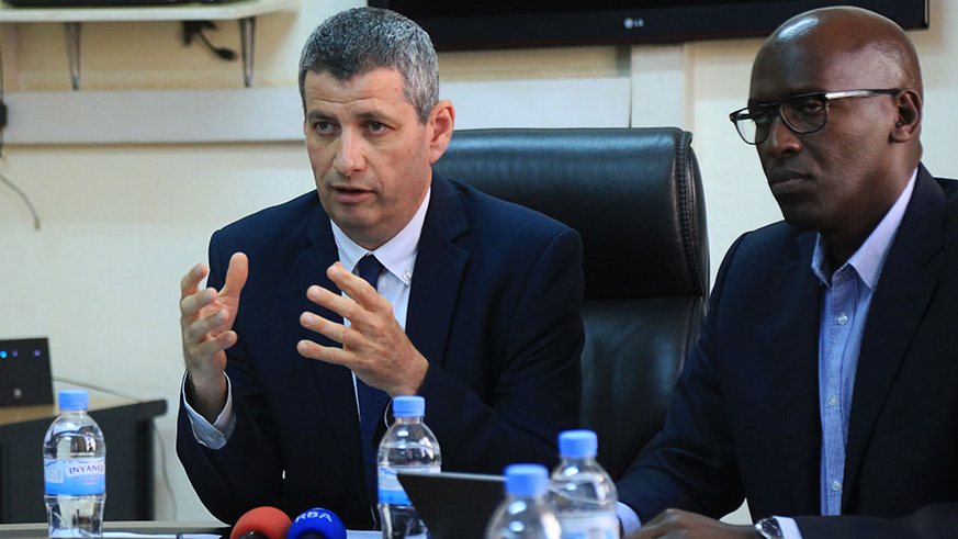 REG chief executive Ron Weiss speaks during the news briefing as Maj. Jean Claude Kalisa, EUCL managing director, looks on in Kigali on Tuesday. Sam Ngendahimana.