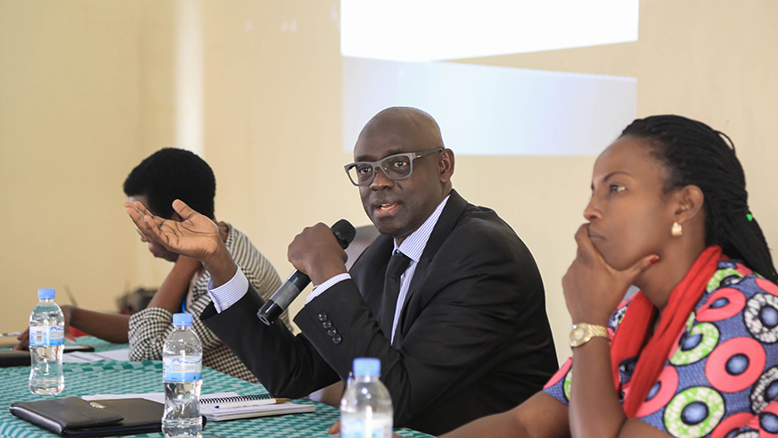 Busingye addresses the district based committees that manage abandoned property as Beata Mukeshimana, Permanent Secretary and Solicitor General in the Ministry of Justice (right), looks on. Nadege Imbabazi.