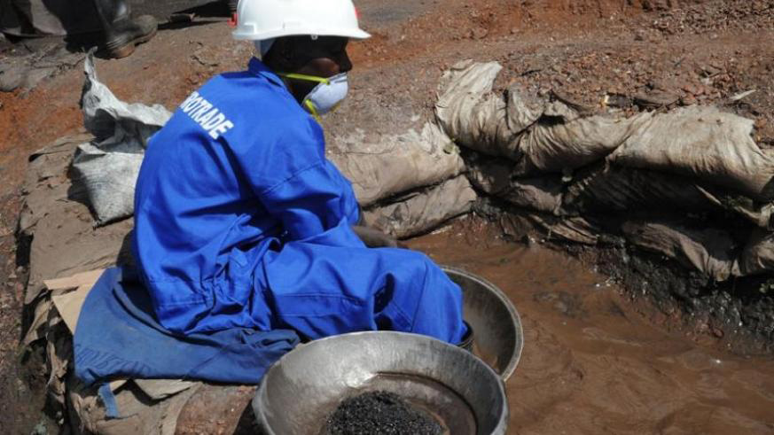 A miner sorts minerals using water. File.