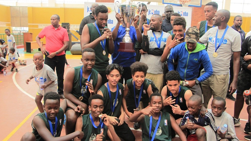 Green Hills Academy players and coaching staff celebrate after beating Sonrise to emerge the victors in the boysu2019 category in the Junior NBA Rwanda league at Amahoro Stadium on Saturday. Courtesy. 