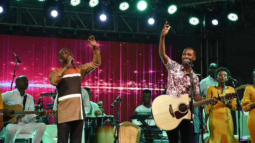 Aimu00e9 Uwimana (left), and Israel Mbonyi. Photo by Frederic Byumvuhore