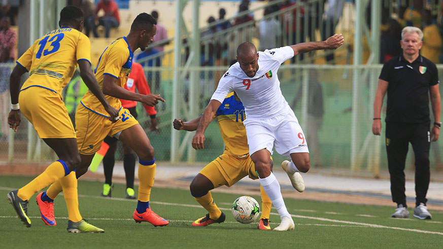 Guineau2019s goal-scorer Martinez Jose Kante (#9) tries to dribble past Rwandau2019s Ally Niyonzima (middle) and right-back Fitina Ombolenga during the two sidesu2019 1-1 draw at Kigali Stadium on Tuesday. Sam Ngendahimana.