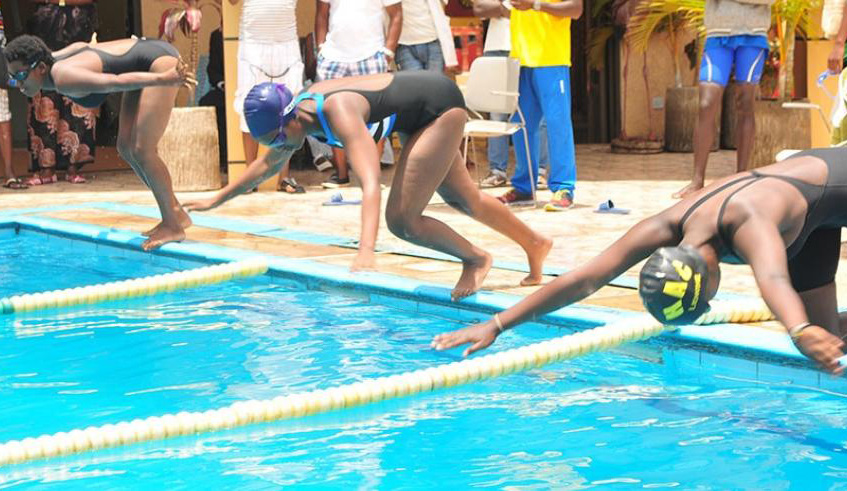Female swimmers dive into the pool during a past competition at Hill Top Hotel in Remera. File photo.