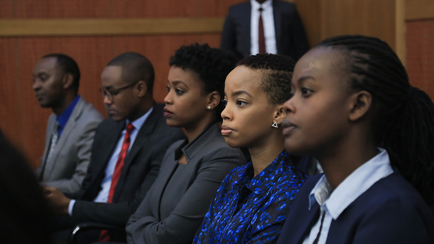 Staff with the Ministry Foreign Affairs look on during the handover ceremony. 