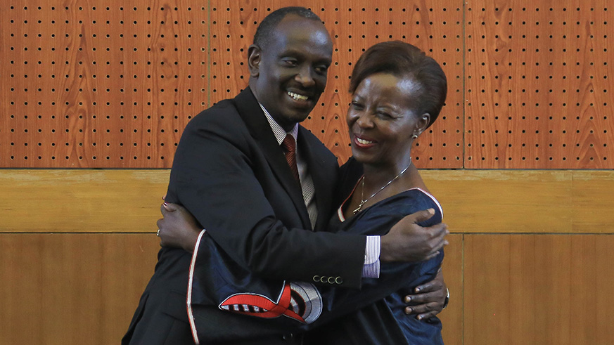 Dr. Richard Sezibera and Louise Mushikiwabo hug after the handover ceremony.
