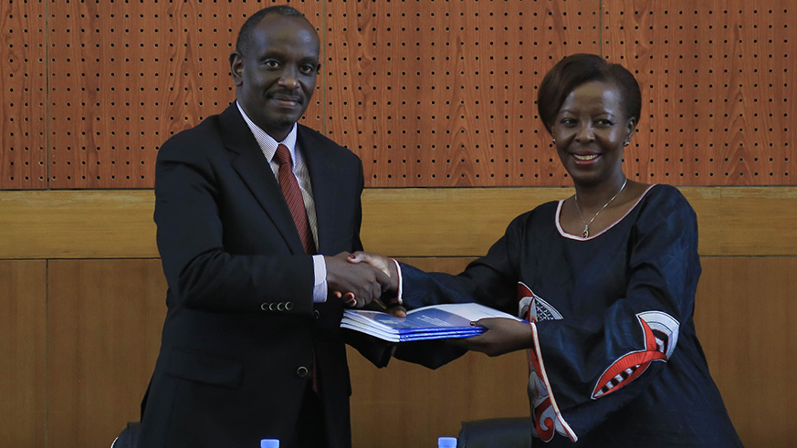 Outgoing Foreign Affairs Minister, Louise Mushikiwabo shows Dr. Richard Sezibera around his new offices after the handover ceremony.